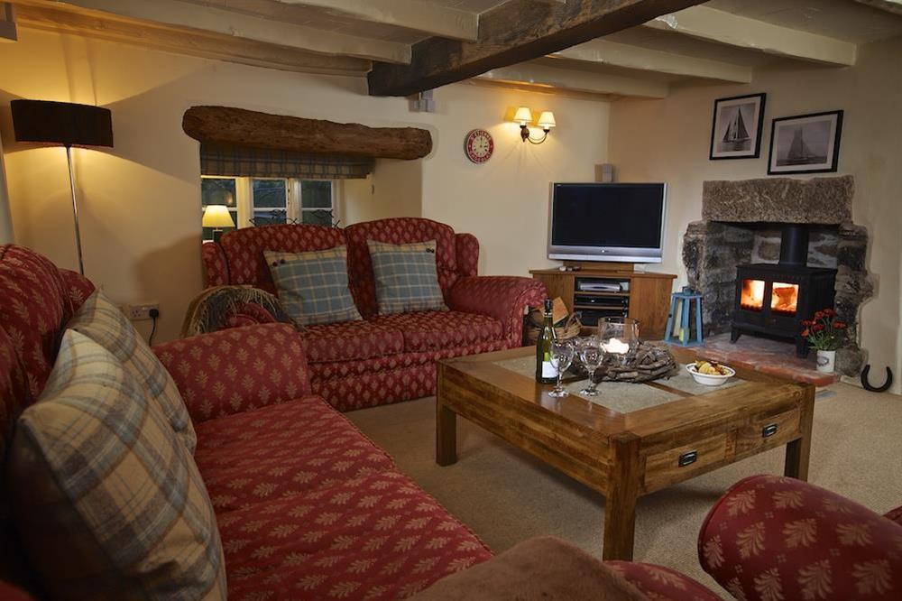 Snug lounge with wood burner at Higher Collaton Cottage in Malborough, Nr Salcombe