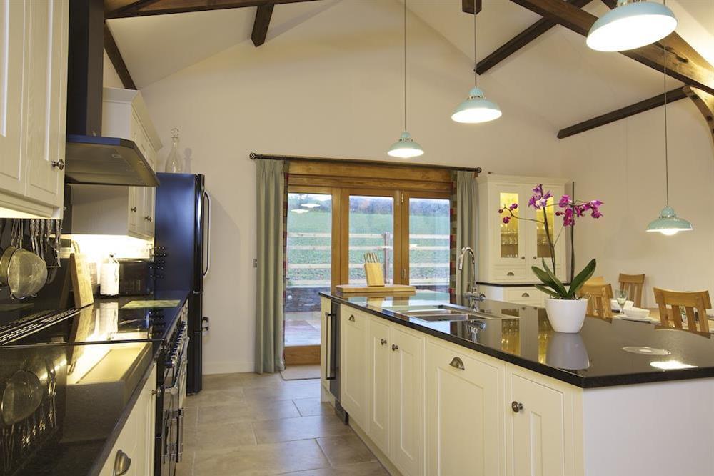 Contemporary kitchen with cream units and black granite worktops at Higher Hill Barn in , Nr Kingsbridge