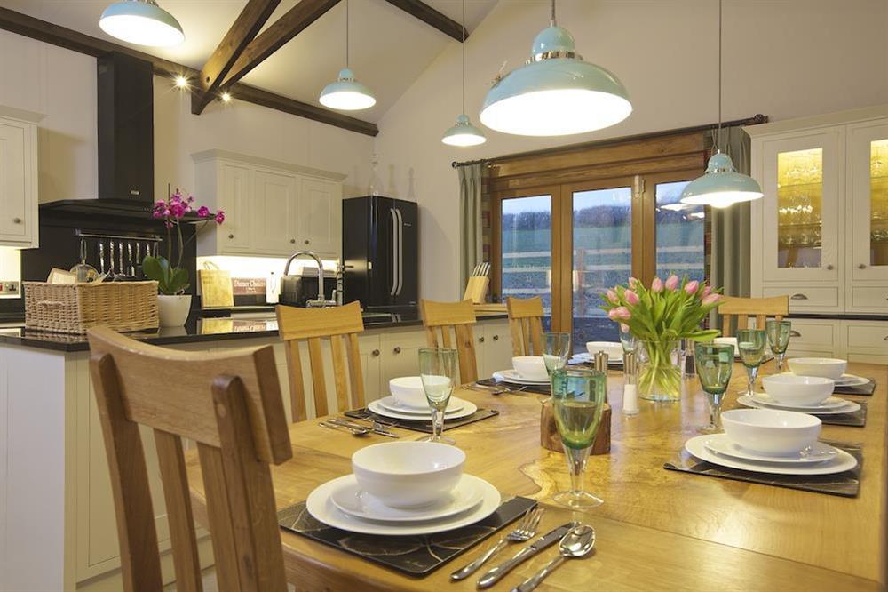 Large kitchen, dining area with doors leading out to the upper terrace at Higher Hill Barn in , Nr Kingsbridge