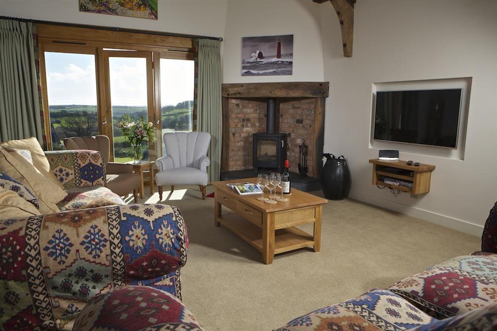 Lounge with wood burning stove at Higher Hill Barn in , Nr Kingsbridge
