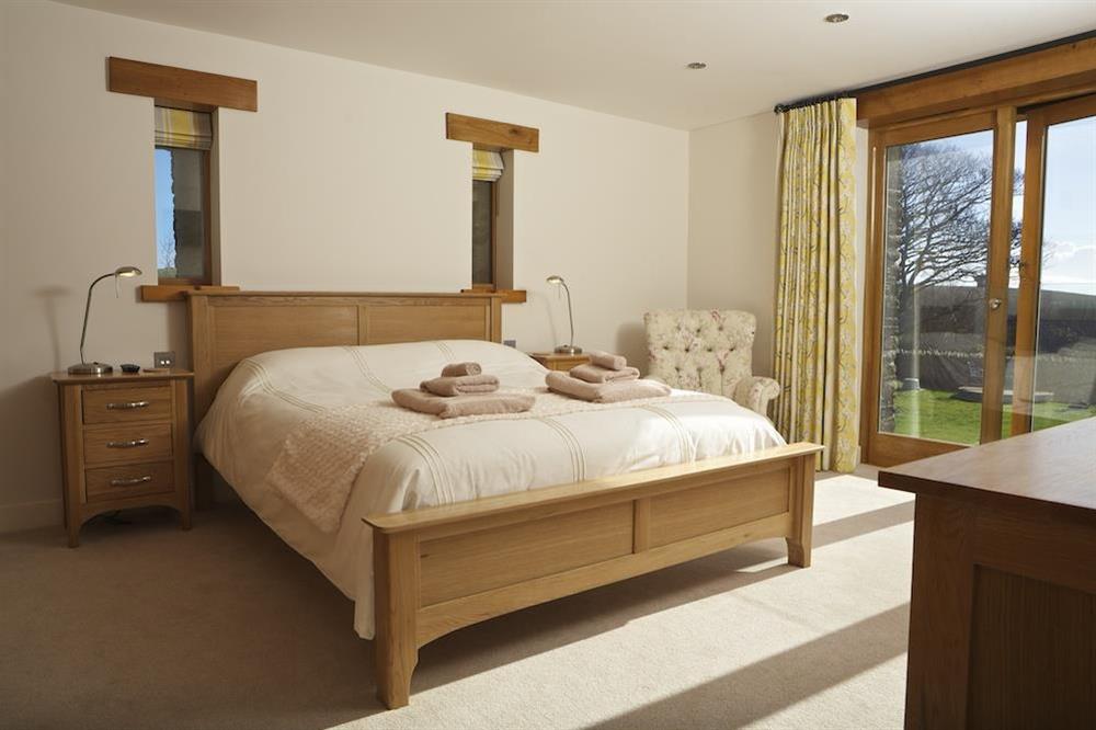 Master bedroom with doors leading to the garden at Higher Hill Barn in , Nr Kingsbridge
