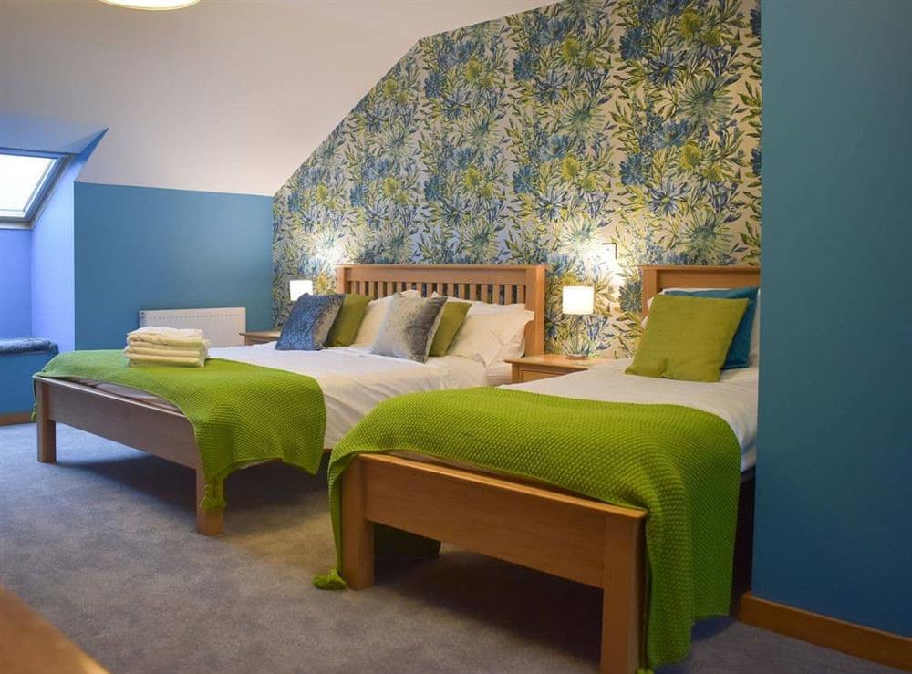 Bright bedroom sleeping up to three guests at Wisteria House, 