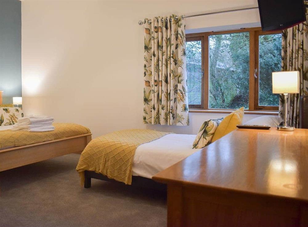 Cosy bedroom boasting single and double beds at Wisteria House, 