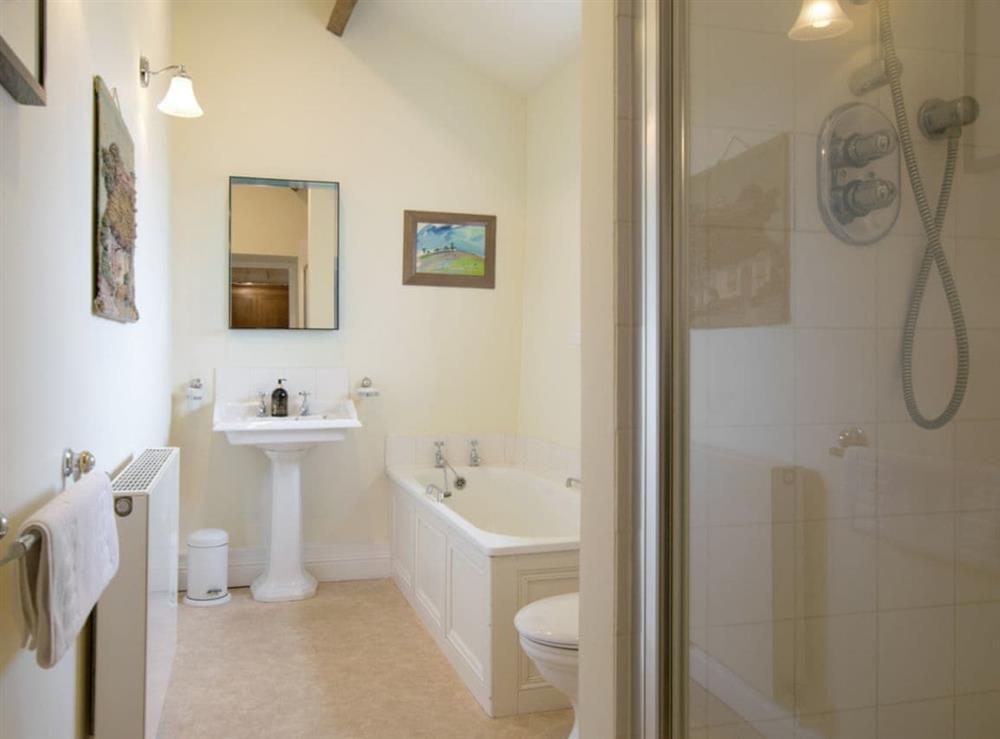 En-suite bathroom with bath and separate shower cubicle at Higher Scarcliffe in Broughton, near Skipton, North Yorkshire