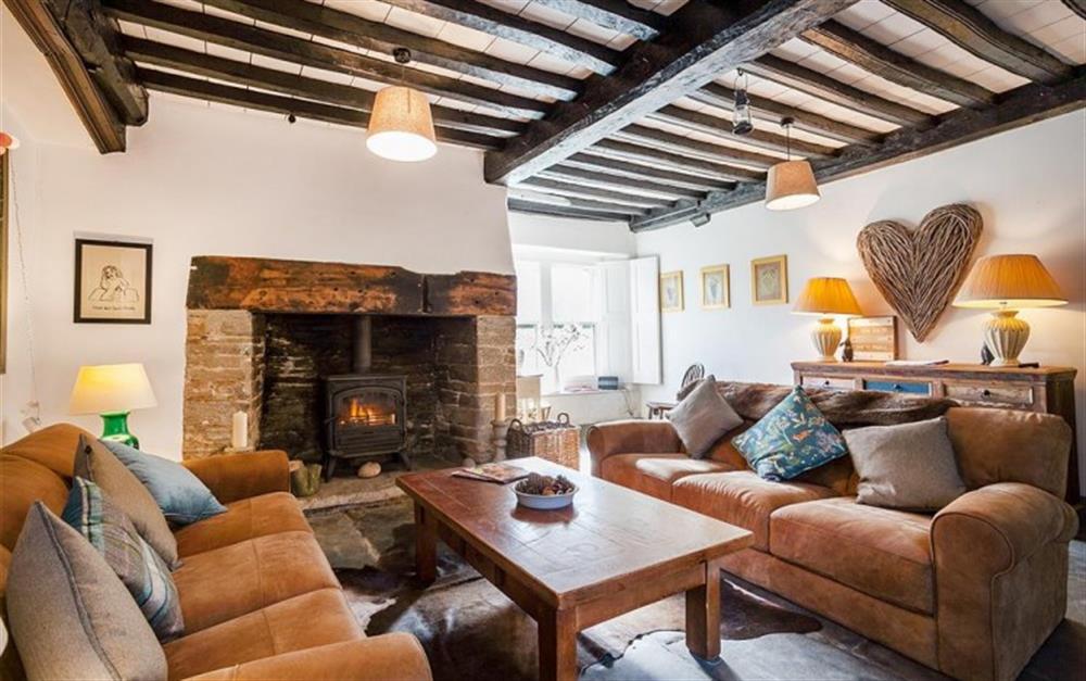 The gorgeous snug with beamed ceiling, slate floors, comfy sofas and log burner.