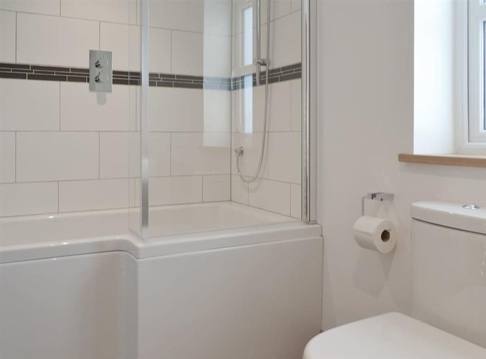 En-suite bathroom with shower over bath at The House, 