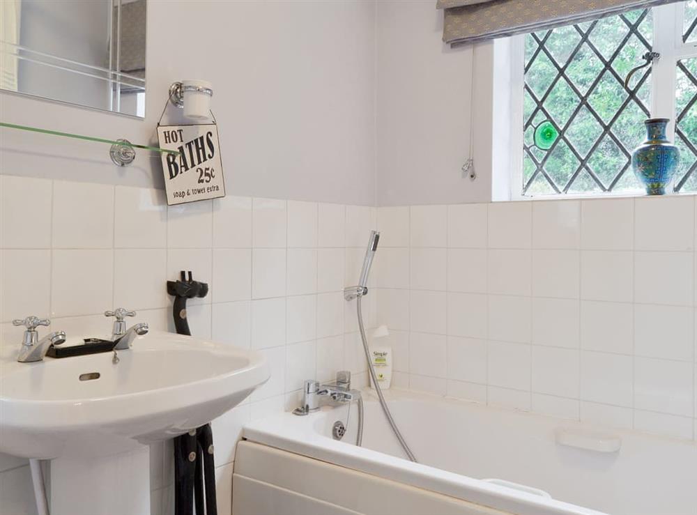 Bathroom with shower over bath at Highmoor Park Cottage in Highmoor, near Henley-on-Thames, Oxfordshire