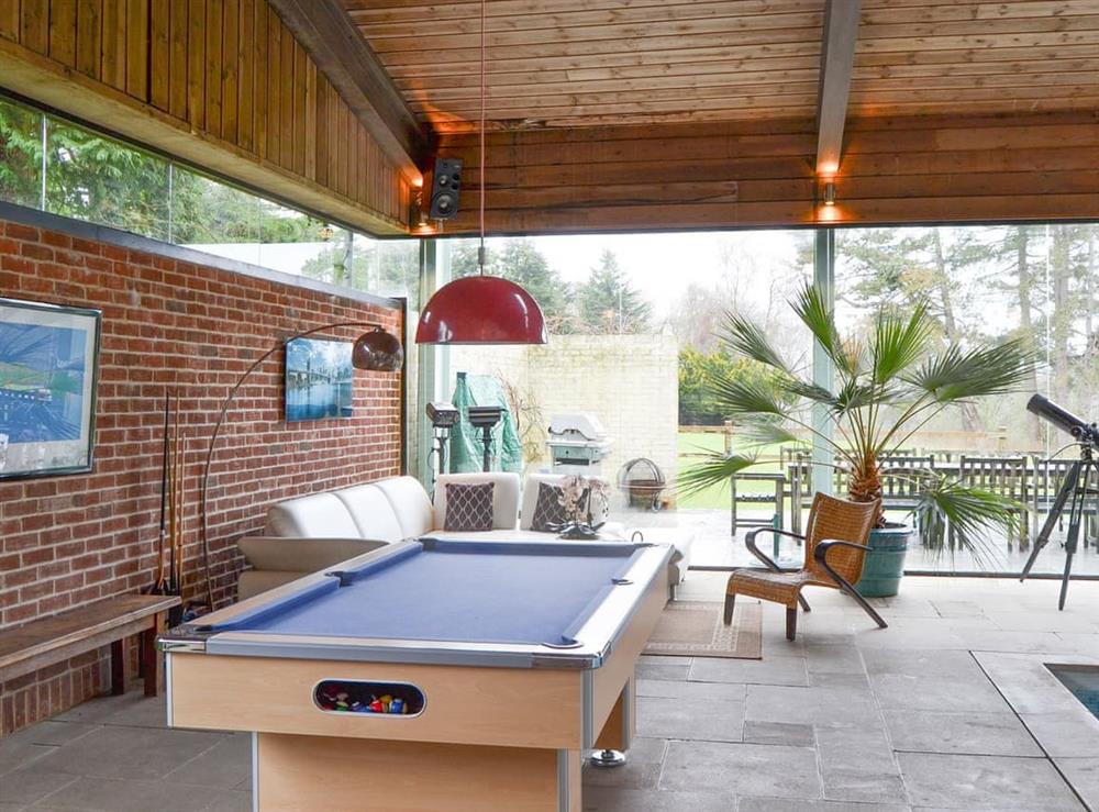 Pool table and seating area of the pool house at Highmoor Park Cottage in Highmoor, near Henley-on-Thames, Oxfordshire
