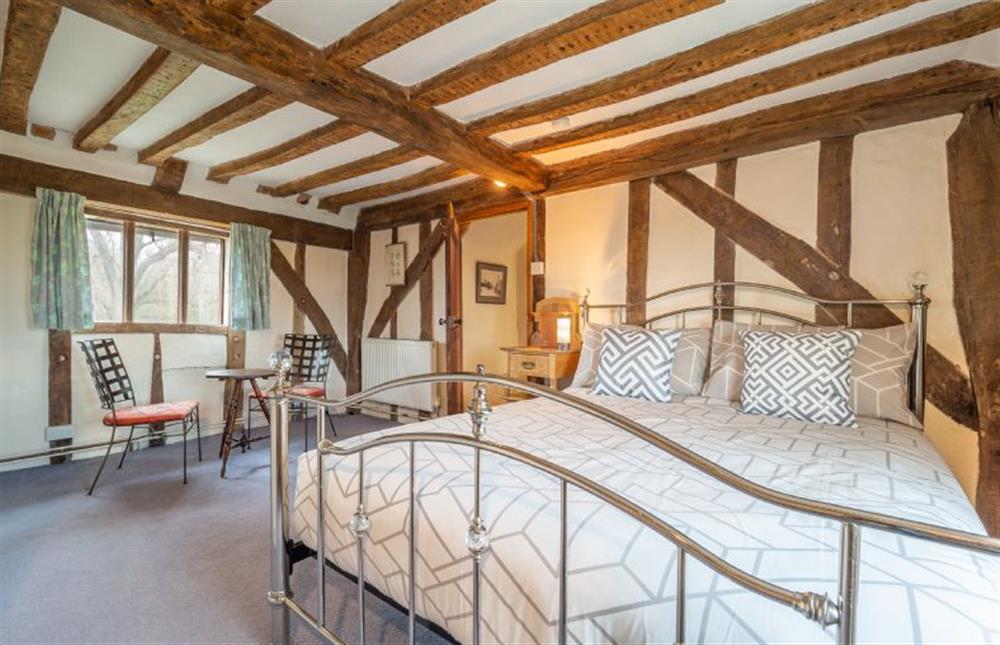 King-size bedroom with traditional beams at Hill Farm House, Huntingfield