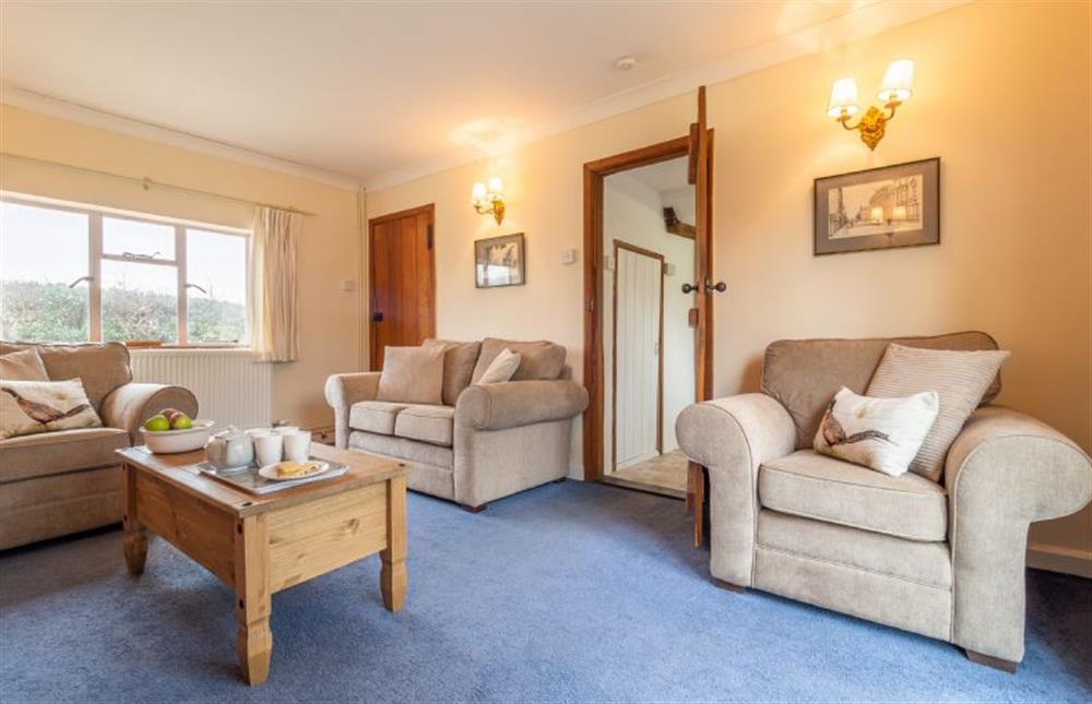 Sitting room with comfortable seating for four guests at Hill Farm House, Huntingfield