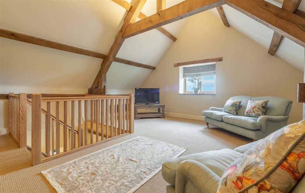 Sitting room with three sofas, armchairs, reading/games area and Smart television at Hill Farm Massingham, Little Massingham