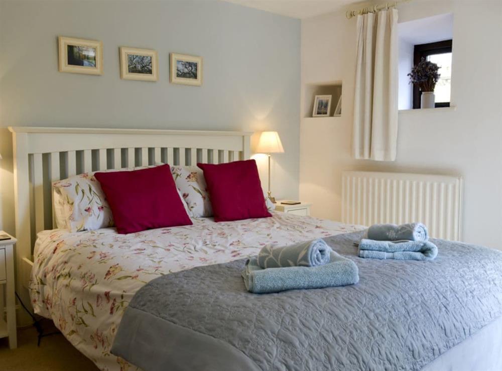 Tranquil bedroom with kingsize bed and en-suite at Hill Top Barn in Starbotton, near Skipton, North Yorkshire