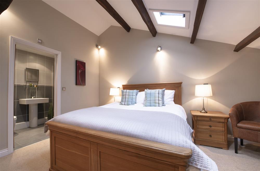 Bedroom one with a 5’ king-size bed and en-suite shower room at Hill Top Farm, Askrigg, Nr Leyburn