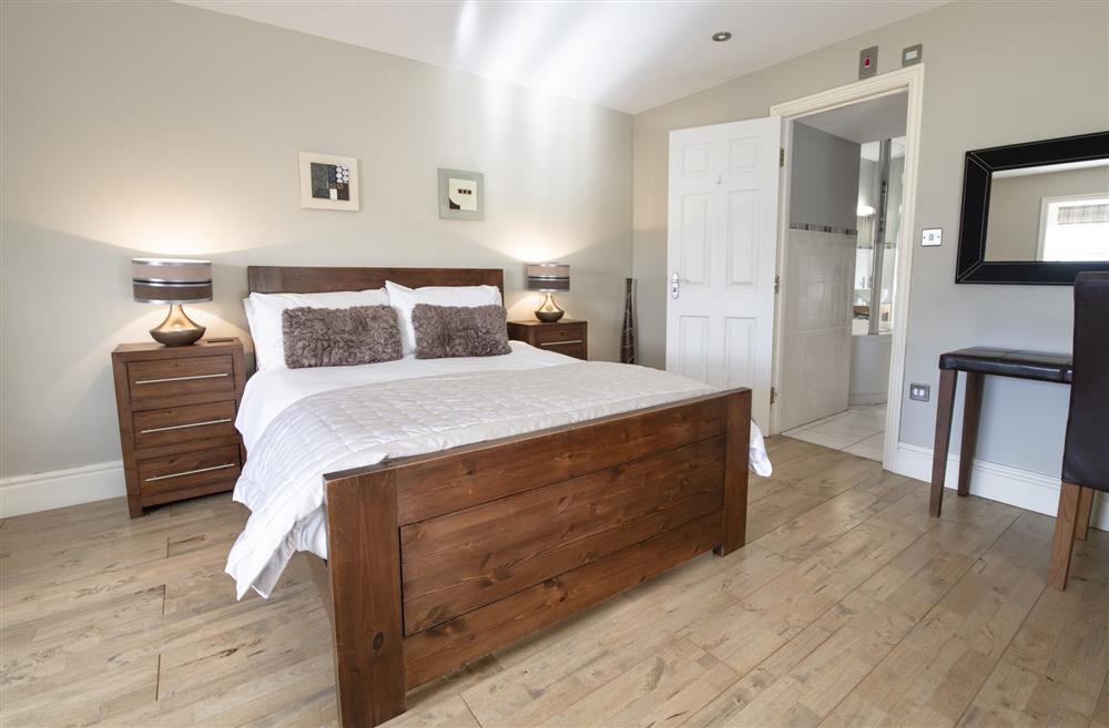 Bedroom six with a 4’6 double bed, wall mounted television and en-suite bathroom at Hill Top Farm, Askrigg, Nr Leyburn