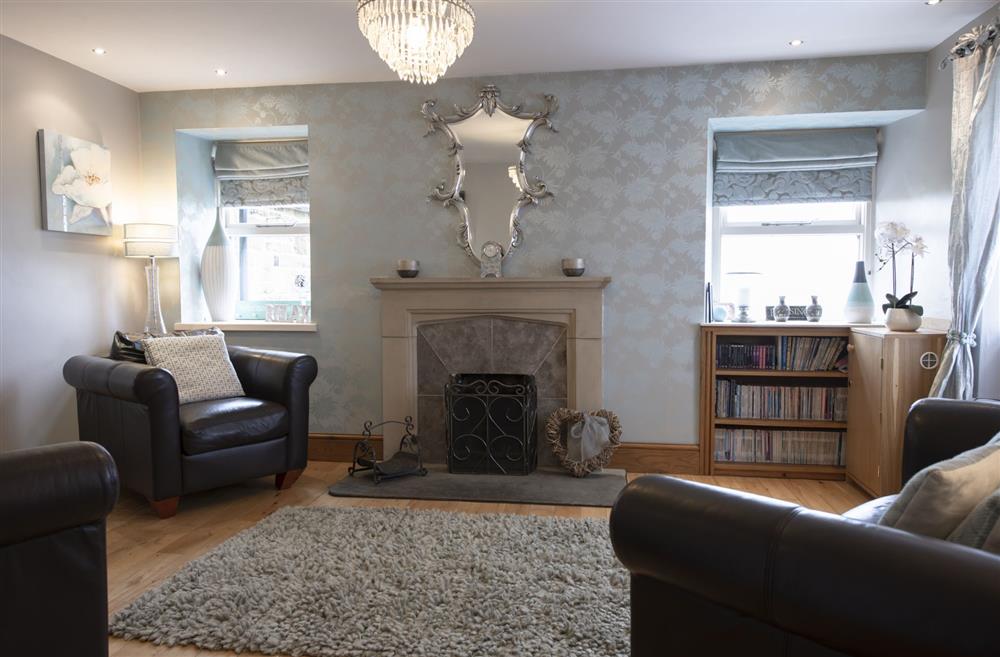 The sitting room enjoys a cosy open fire place and is an ideal setting for after dinner relaxation