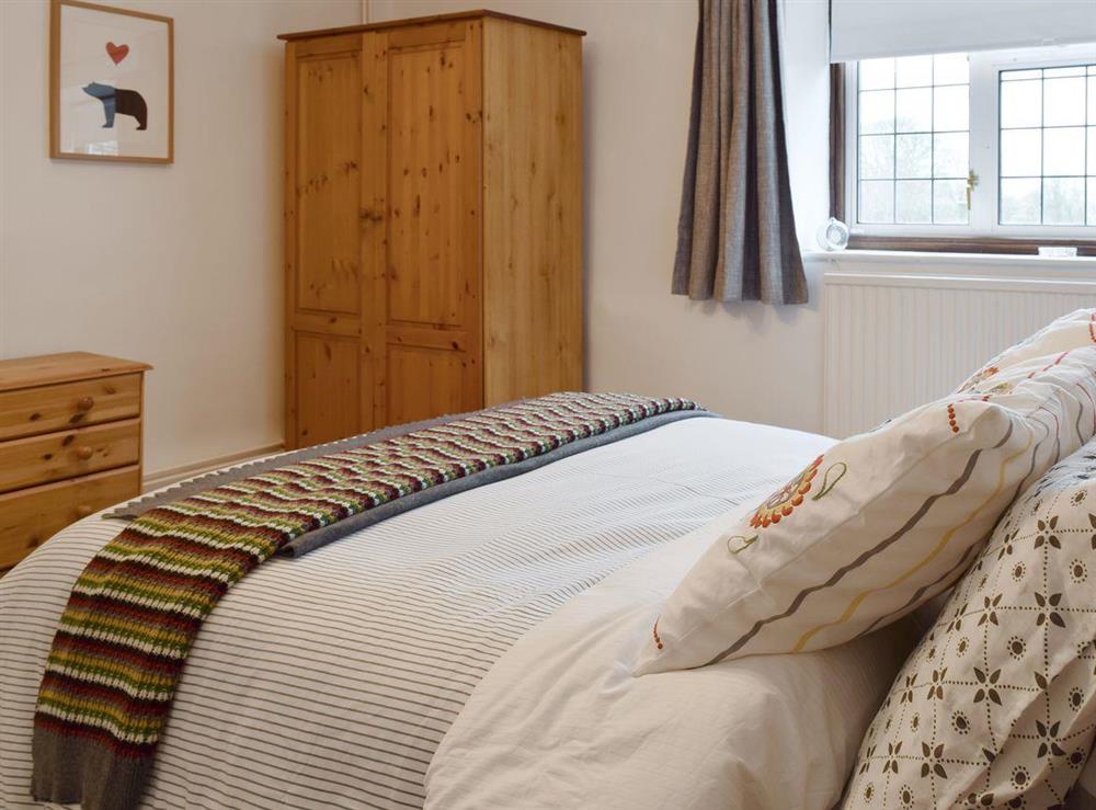 Spacious bedroom with TV and ample storage at Hill View Cottage in Snowshill, Worcestershire