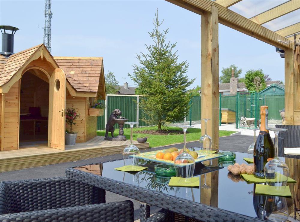 Outdoor eating area within covered terrace at Hillcrest House in Brown Edge, near Leek, Staffordshire
