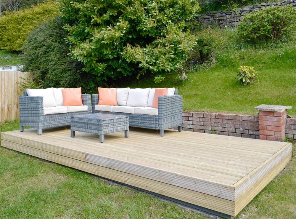 Decked patio area with outdoor furniture at Hillside Retreat in Prestatyn, Denbighshire