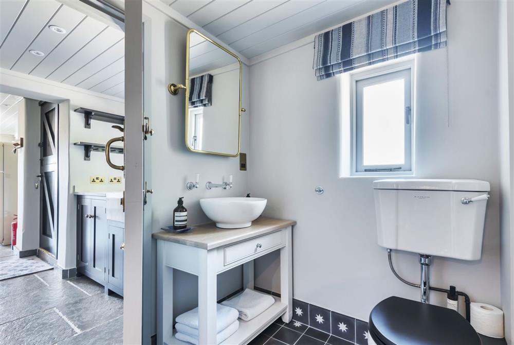 Shower and cloakroom with a view to the utility area beyond at Hilltop Cottage, Wimborne