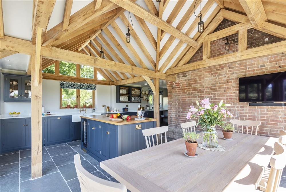 The impressive open-plan kitchen and dining area with Smart television at Hilltop Cottage, Wimborne