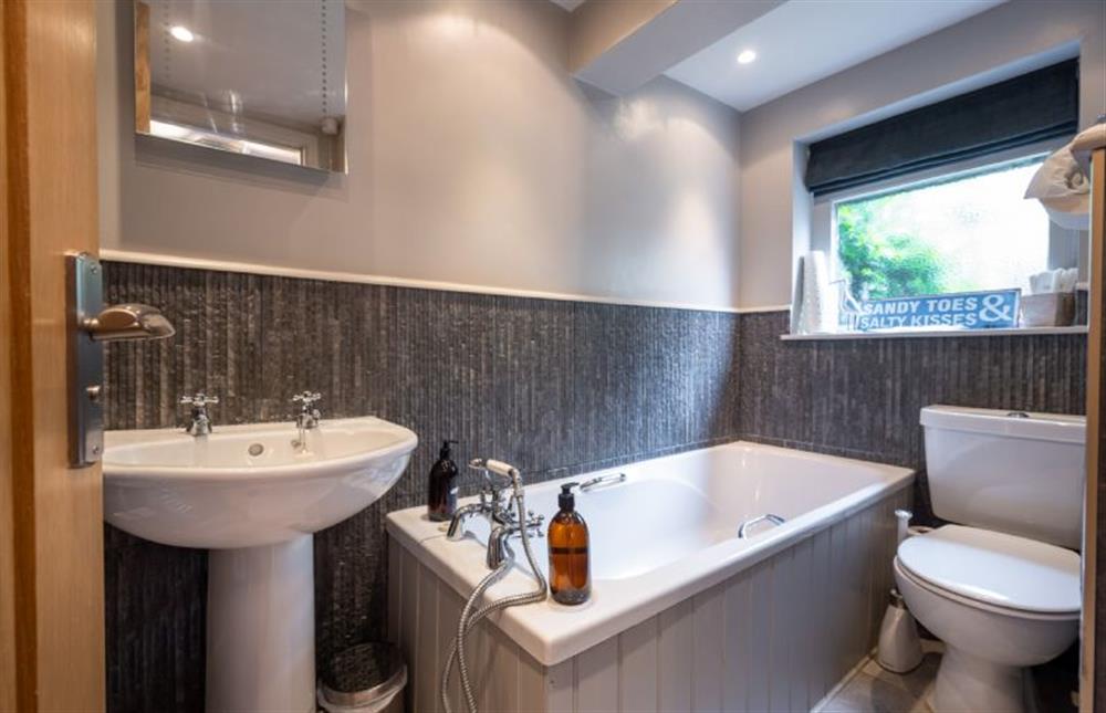 Family bathroom with bath and hand held shower at Hillview Lodge, Brancaster Staithe near Kings Lynn