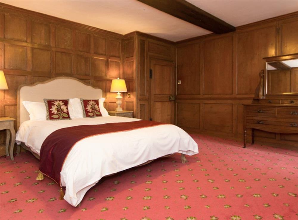 Wood panelled double bedroom at Hockwold Hall in Hockwold, near Thetford, Norfolk