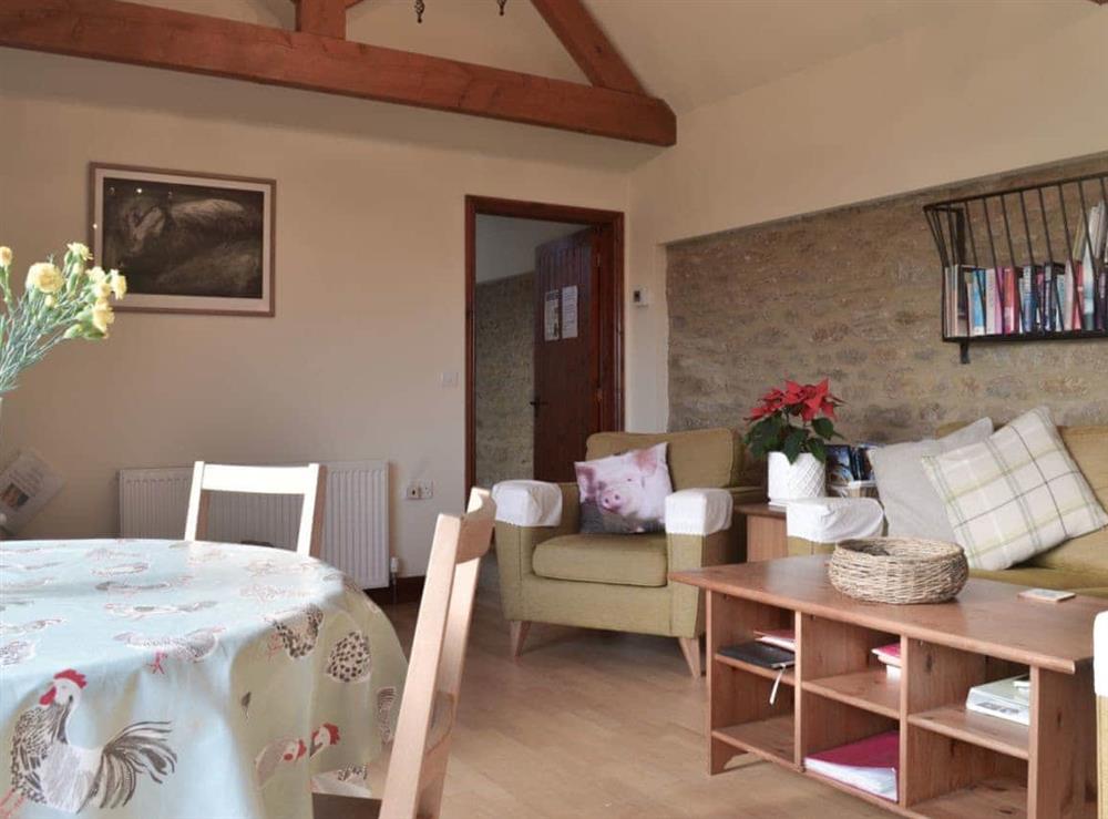 Lovely open plan living area with feature stone wall at Hog Pits in East Tytherton, Wiltshire