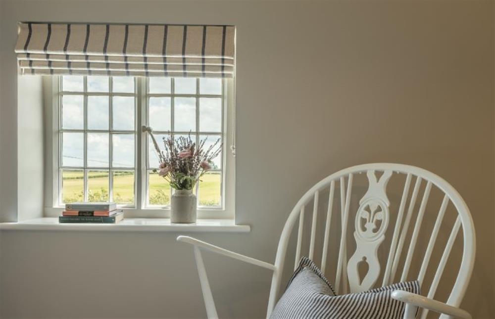 First floor: Vintage rocking chair in the master bedroom at Holkham Skies, Wells-next-the-Sea
