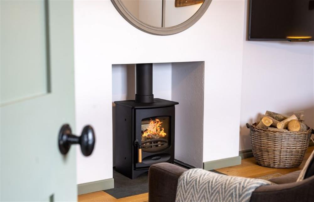 Ground floor: Bright and peaceful living area with wood burning stove (photo 4) at Holkham Skies, Wells-next-the-Sea