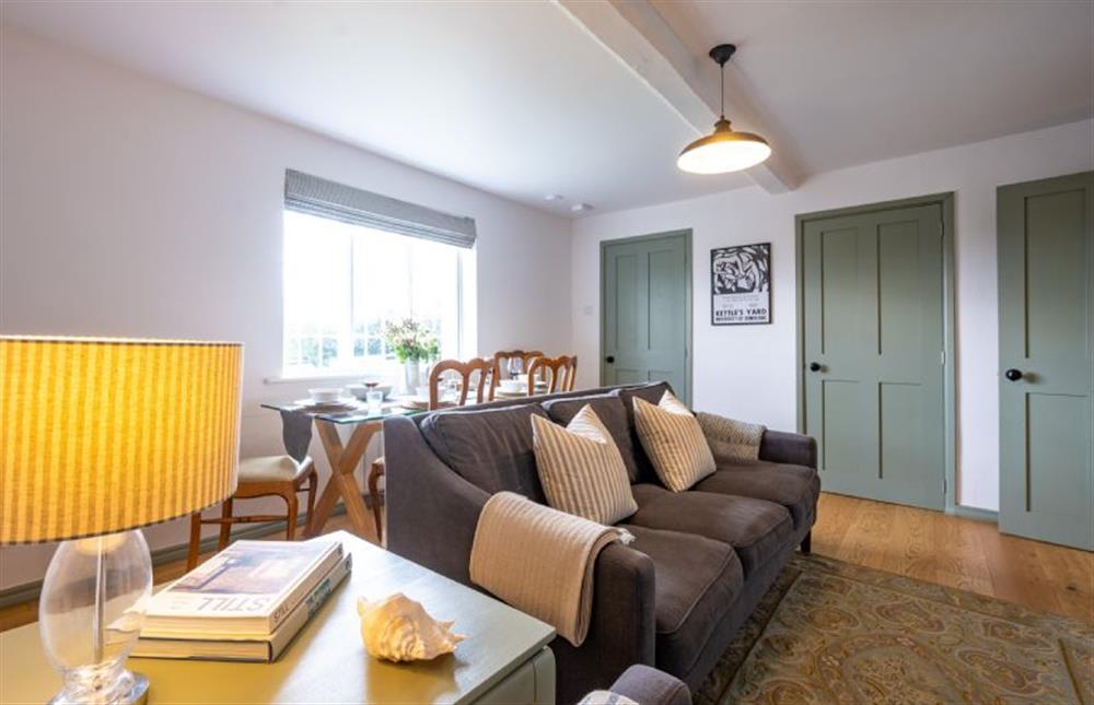 Ground floor: Comfortable sitting/dining room with wood burning stove (photo 2) at Holkham Skies, Wells-next-the-Sea