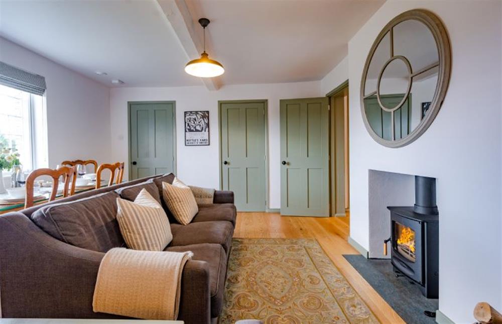 Ground floor: Comfortable sitting/dining room with wood burning stove (photo 3) at Holkham Skies, Wells-next-the-Sea