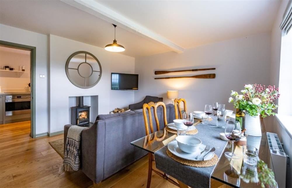 Ground floor: Sitting/dining room with wood burning stove (photo 2) at Holkham Skies, Wells-next-the-Sea