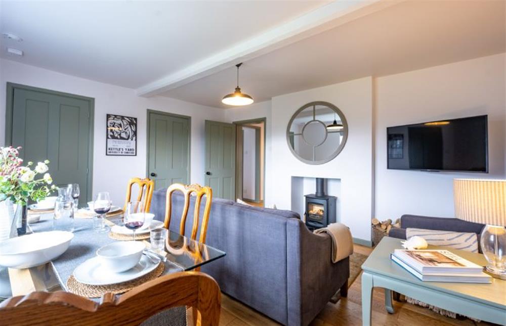 Ground floor: Sitting/dining room with wood burning stove (photo 4) at Holkham Skies, Wells-next-the-Sea