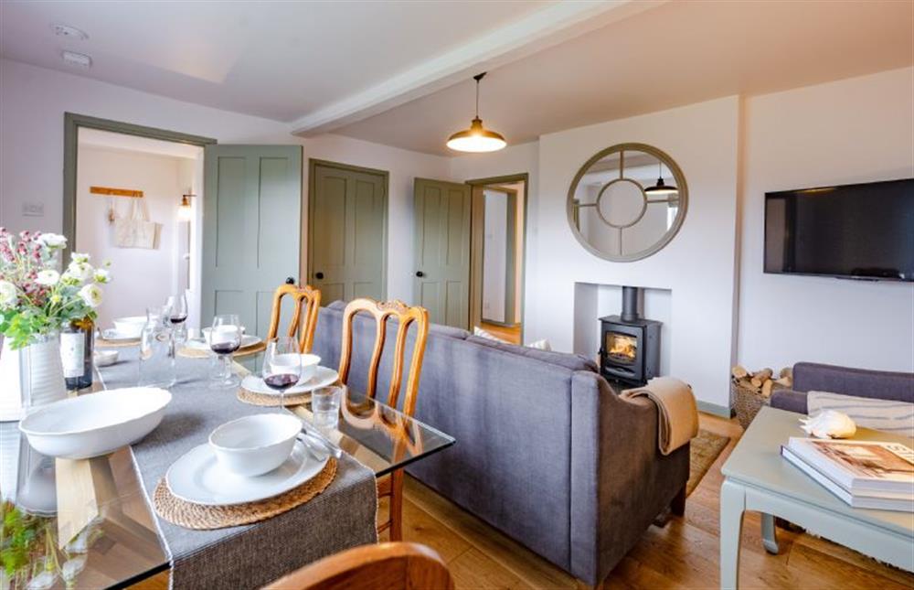 Ground floor: Sitting/dining room with wood burning stove at Holkham Skies, Wells-next-the-Sea