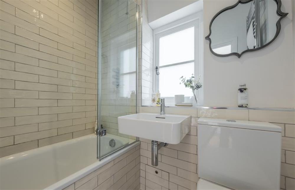 Ground floor: The bathroom has bath with shower over at Holkham Skies, Wells-next-the-Sea