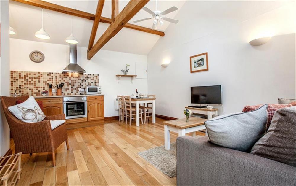 Open plan living & kitchen are with exposed oak beams at Hollie Cottage in Seaton