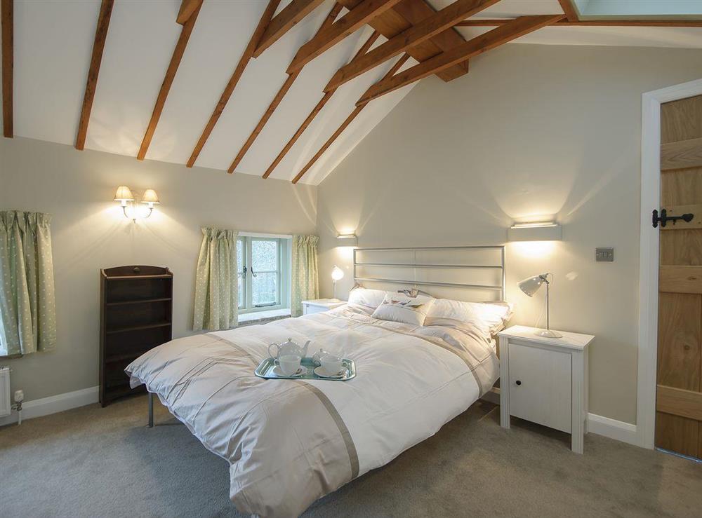 Large beamed double bedroom at Holliers Cottage in Middle Barton, near Chipping Norton, Oxfordshire