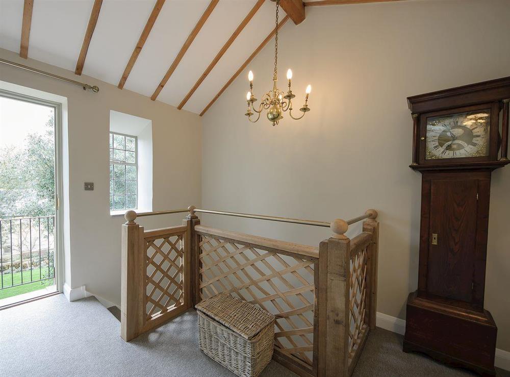 Stairs to landing with French doors leading to balcony