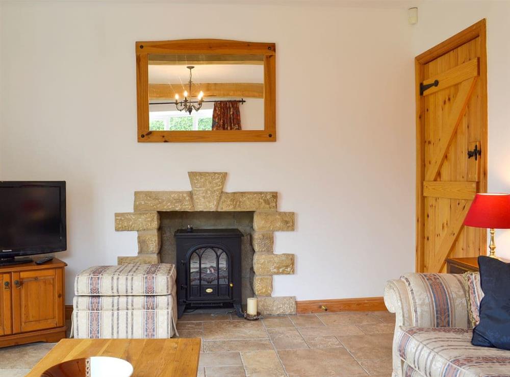 Comfy living room with patio doors at Holly Cottage in Handley, near Chesterfield, Derbyshire