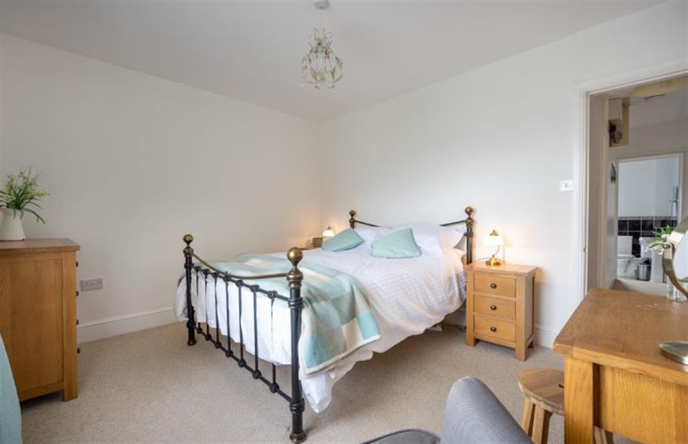 First floor: Master bedroom with king-size bed at Holly Cottage, Heacham near Kings Lynn