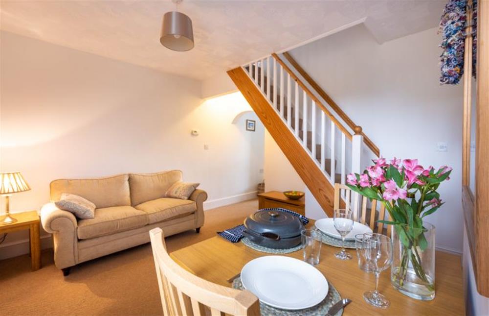 Ground floor: Dining room with comfortable sofa at Holly Cottage, Heacham near Kings Lynn