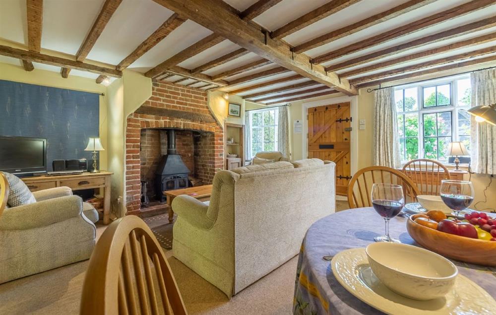 Sitting room with dining area at Holly Cottage, Huntingfield