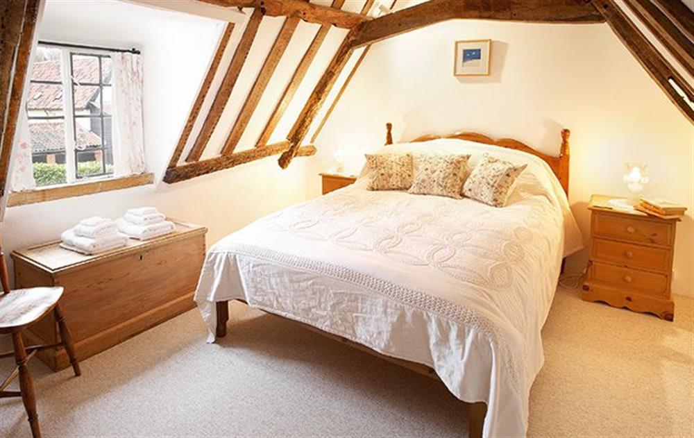 Wooden spiral staircase to second floor: Double bedroom with 4'6 bed at Holly Cottage, Huntingfield