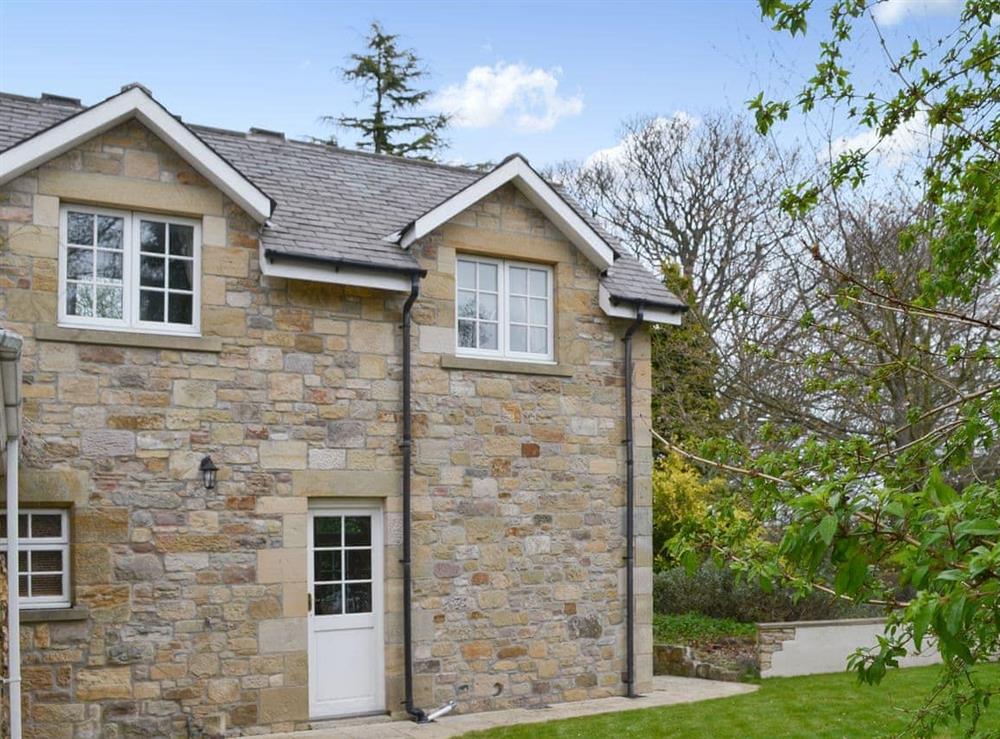 Exterior with enclosed private garden at Holly Cottage in Longhoughton, near Alnwick, Northumberland, England