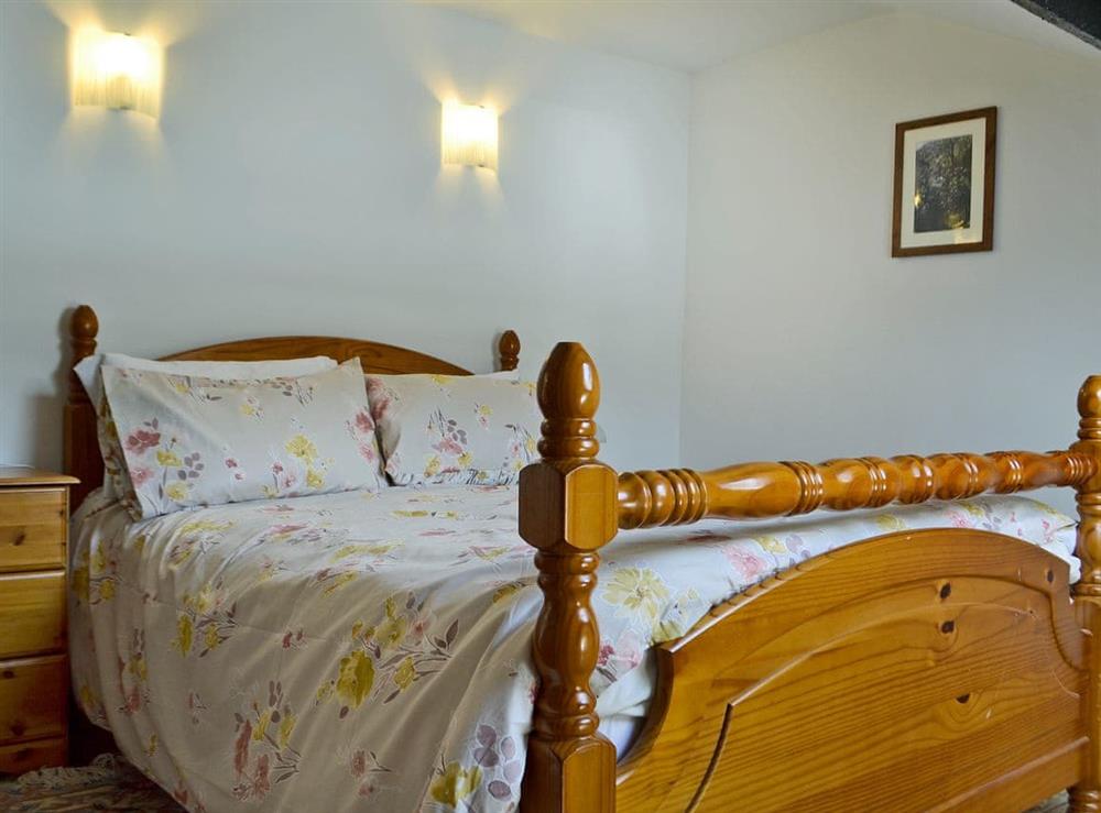 Relaxing double bedroom with kingsize bed at Holly Cottage in Lower Cwmtrch, near Ystradgynlais, Powys