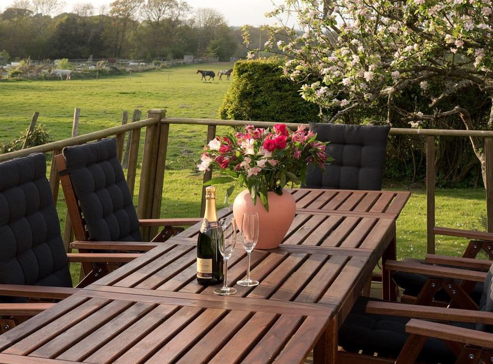 Delightful decked area with table and chairs overlooking the surrounding fields at Holly Cottage in Pett, E. Sussex., East Sussex