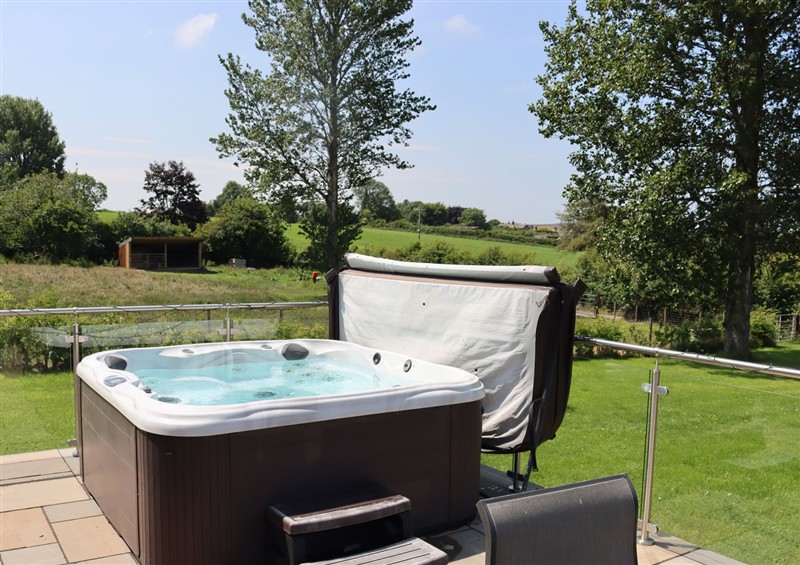 Relax in the hot tub at Holly Lodge, Lloc near Caerwys