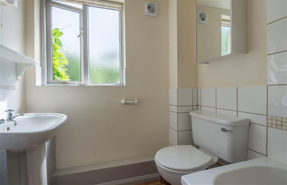 Ground floor: Family bathroom has bath with shower over at Hollyhock, Houghton near Kings Lynn