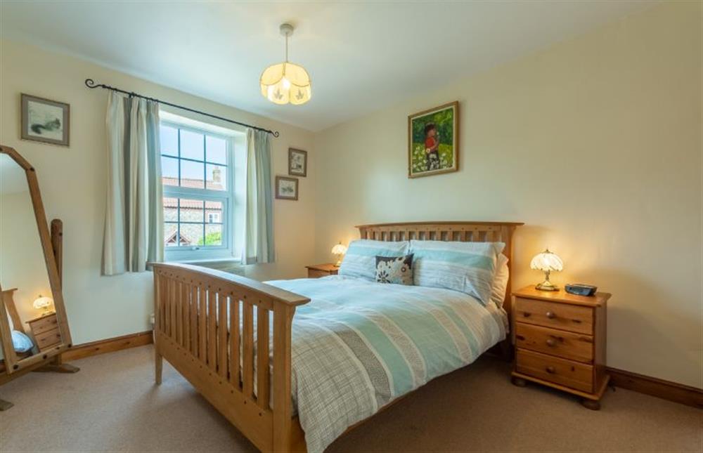 Master bedroom with double bed and freestanding mirror at Hollyhocks, Docking near Kings Lynn