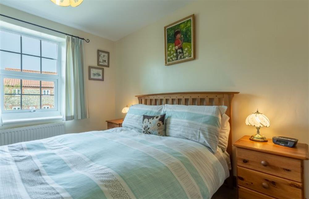 Master bedroom wood frame double bed at Hollyhocks, Docking near Kings Lynn